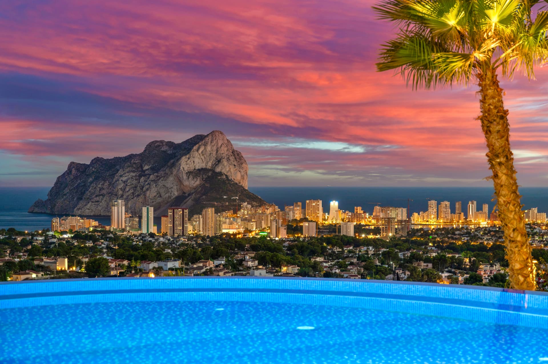 The infinity pool dissolves into the bay.