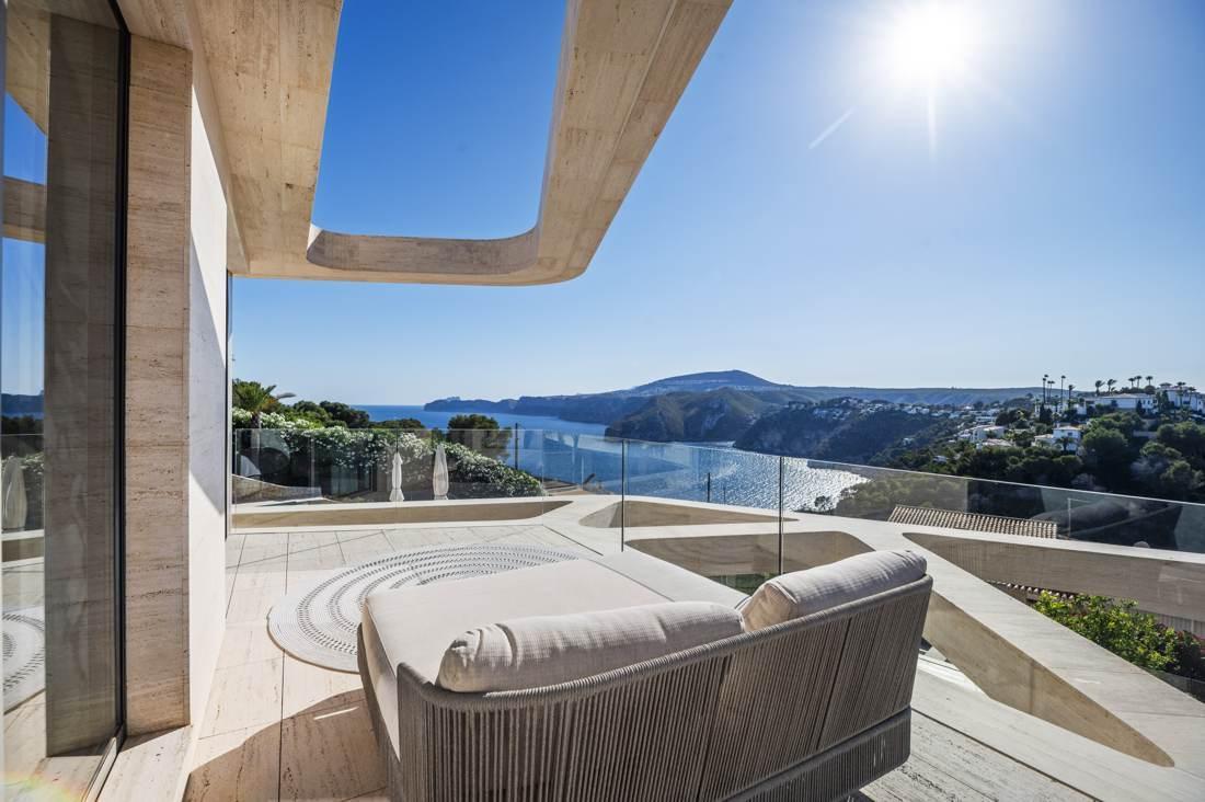 Sunbeds, travertine, and the open sea.