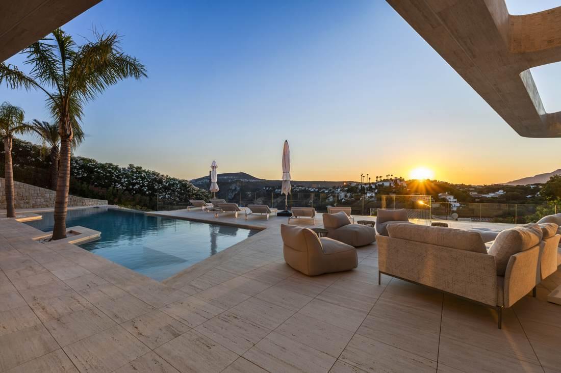 The pool terrace as the sun goes down over Jávea.